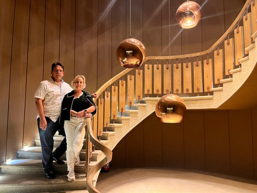 Two people on a wine tour in Bordeaux by a staircase at Chateau Yquem